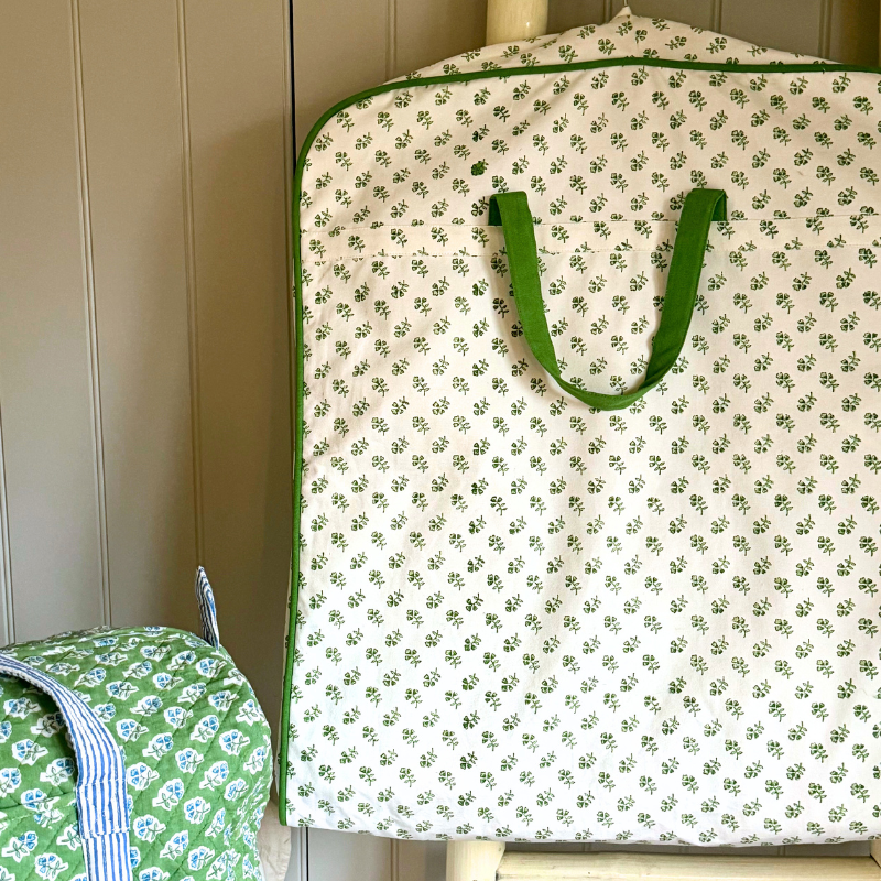 Green and white floral-patterned clothes garment bag carrier