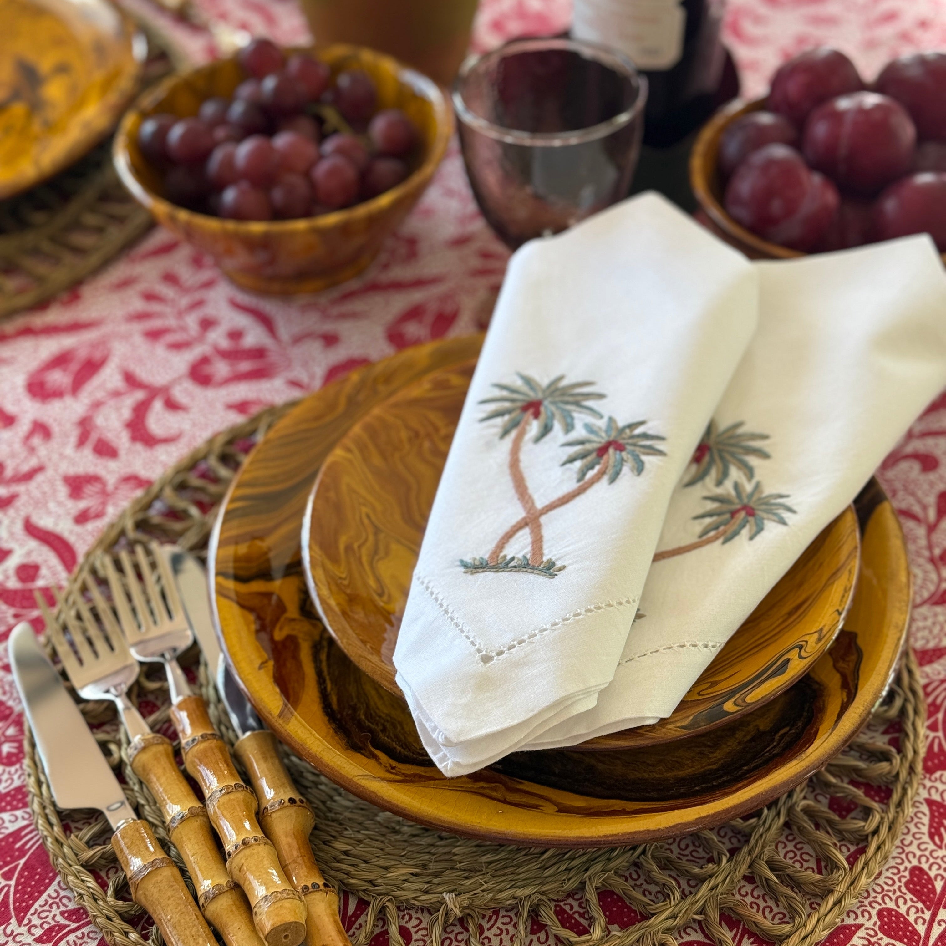Napkins with palm trees embroidered on each corner