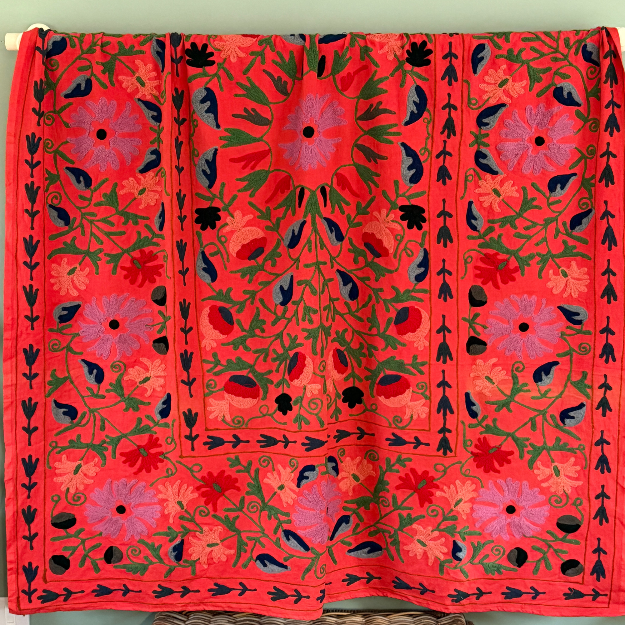 A unique, one-off hand embroidered cotton floral Suzani textile in a beautiful colour palette on Deep Coral/Orange ground. 