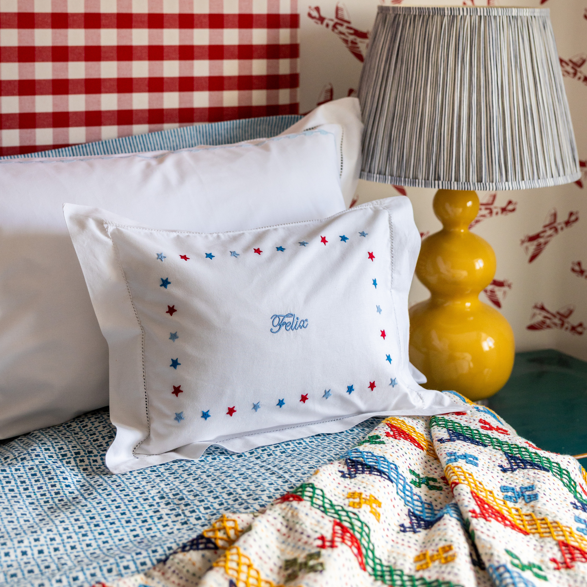 Baby pillowcase with hand embroidered border of mini stars. 