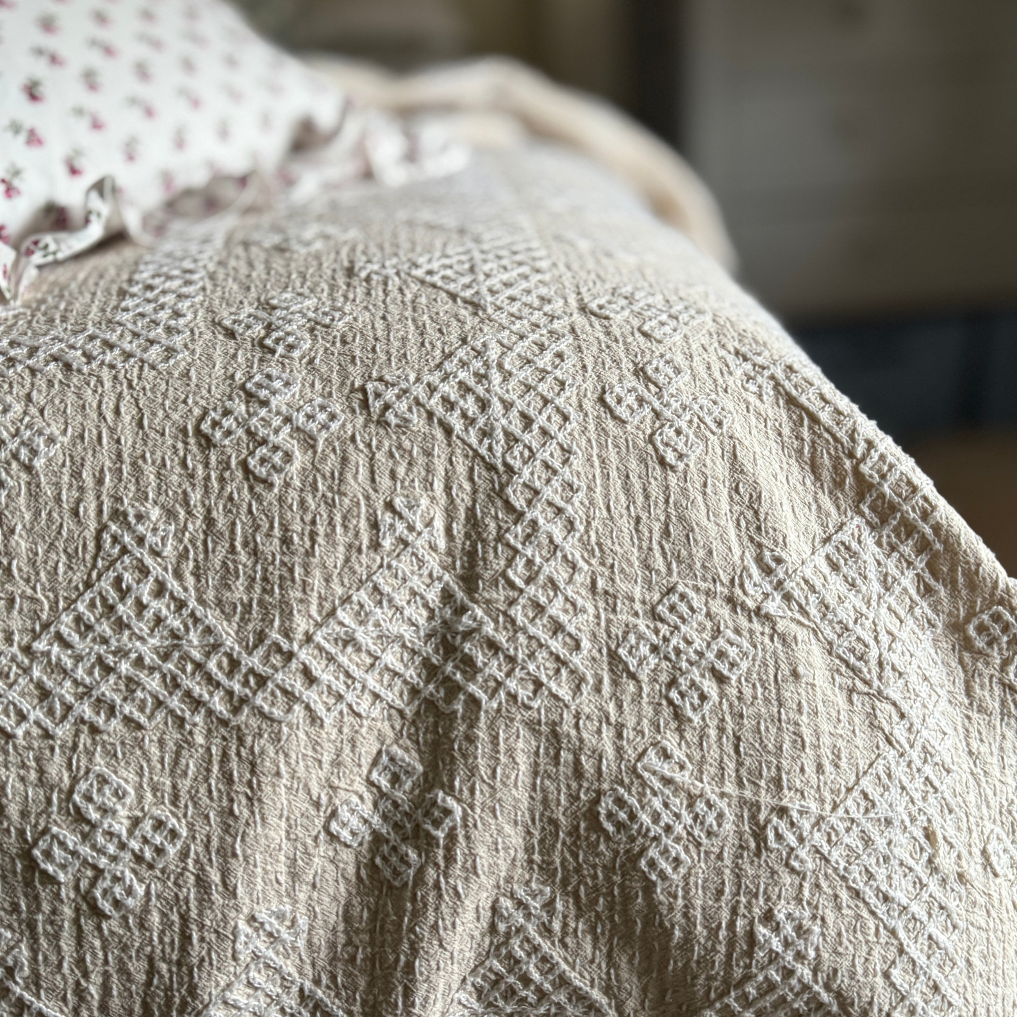 A lightweight kantha bedspread with beautiful hand embroidery with cream and white embroidery