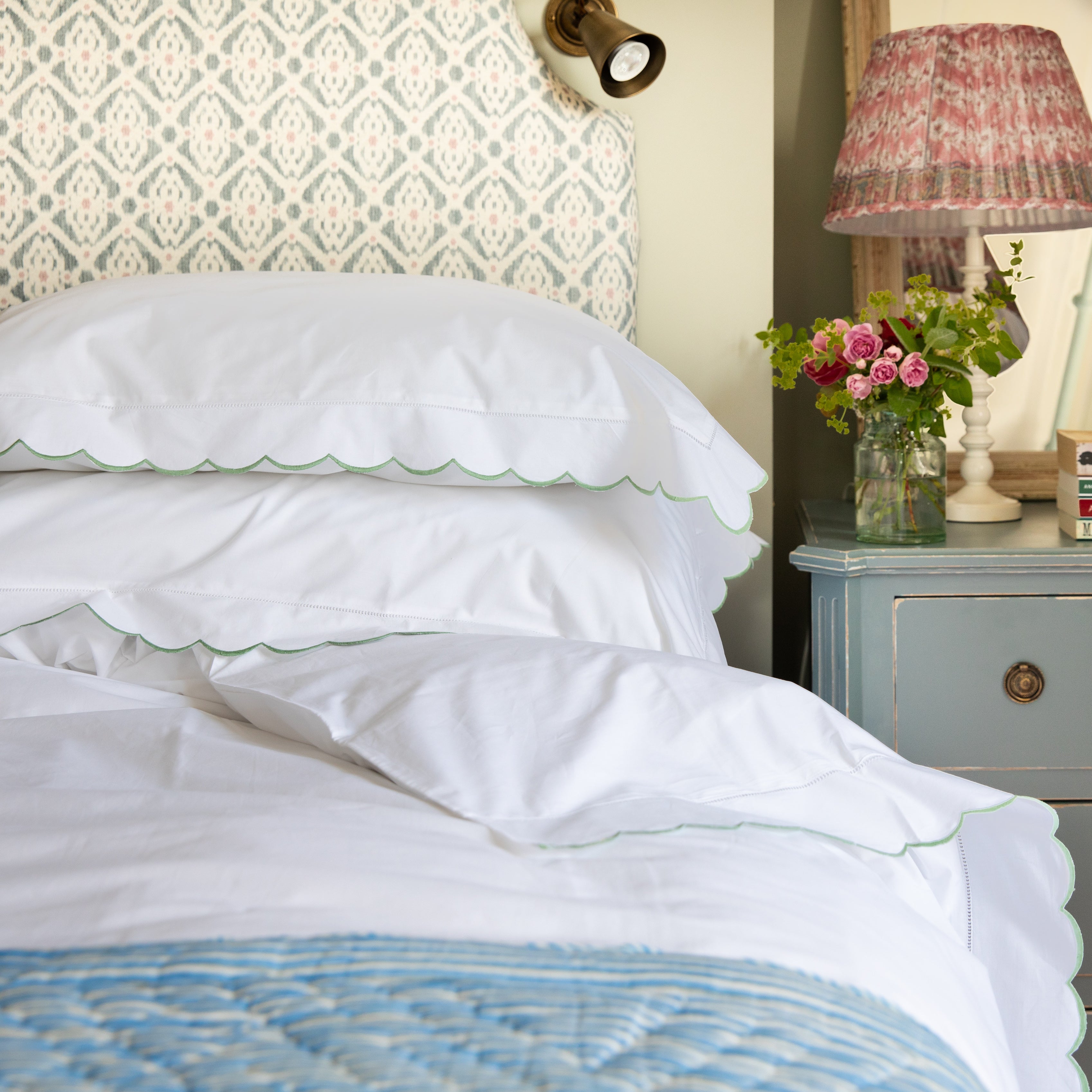 Beautiful cotton white duvet cover featuring a pretty sage green scalloped border.